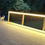 warm white LEDs lighting the handrail of this decking at night